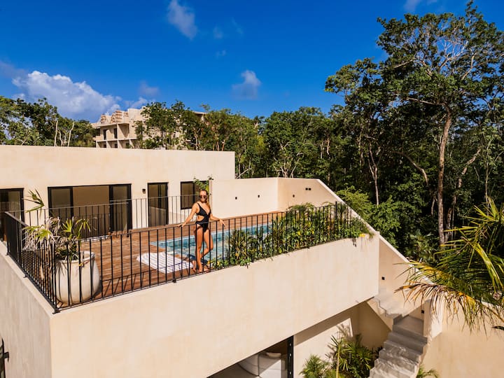 Casa Dalida bright living room with large openings to jungle