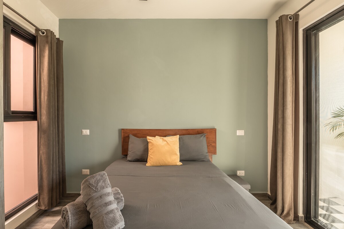 Casa Sueño outdoor terrace with dining area surrounded by lush jungle vegetation